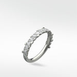 Lark & Berry's Abelia contemporary eternity ring in white gold with scattered marquise and round diamonds.