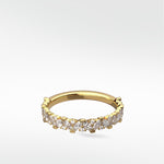 The Abelia Diamond Ring in yellow gold, featuring a contemporary eternity band with marquise and round diamonds.