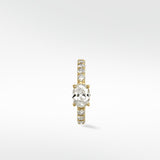 Front view of the Modernist Oval Diamond Hoop with a central oval diamond and a pavé diamond band set in yellow gold.