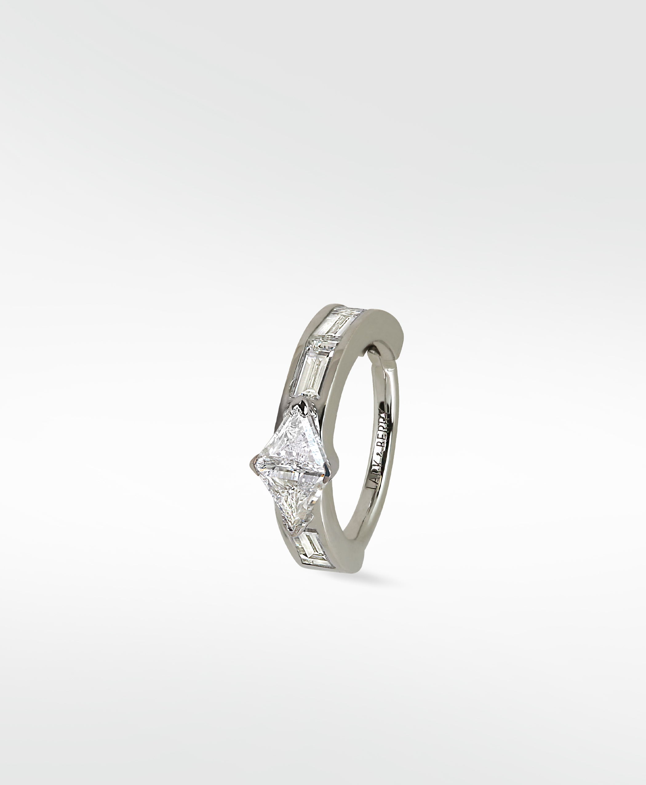 Modernist hoop earring in white gold with a triangle diamond and channel-set baguette diamonds.