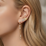 Lark & Berry's gold Celestial Chain Drop Earring with mixed-cut diamonds, styled in a curated ear stack on a model.