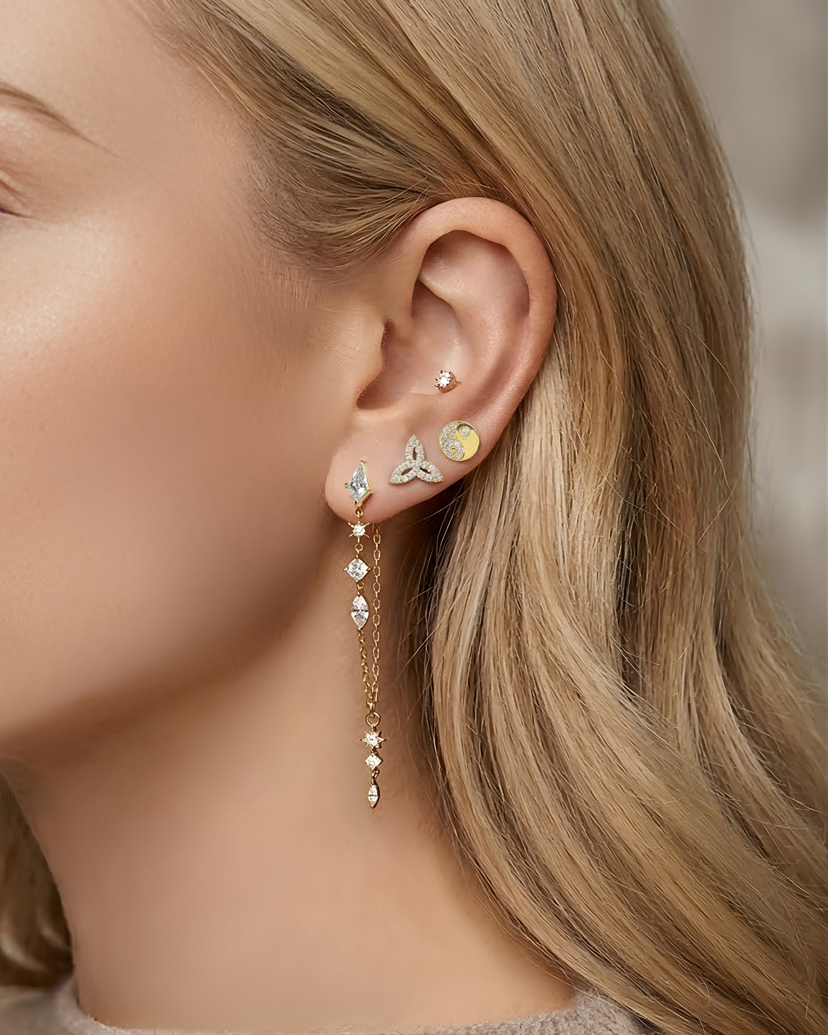 Lark & Berry's gold Celestial Chain Drop Earring with mixed-cut diamonds, styled in a curated ear stack on a model.